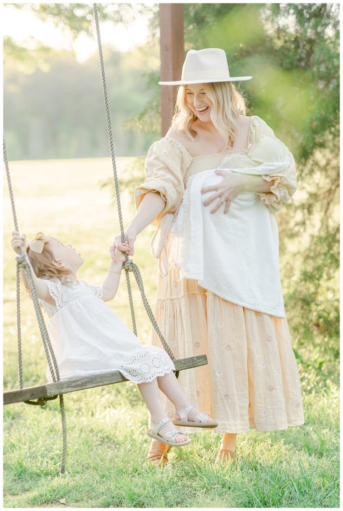 Huntsville Motherhood Photographer, mom pushing girl on swing