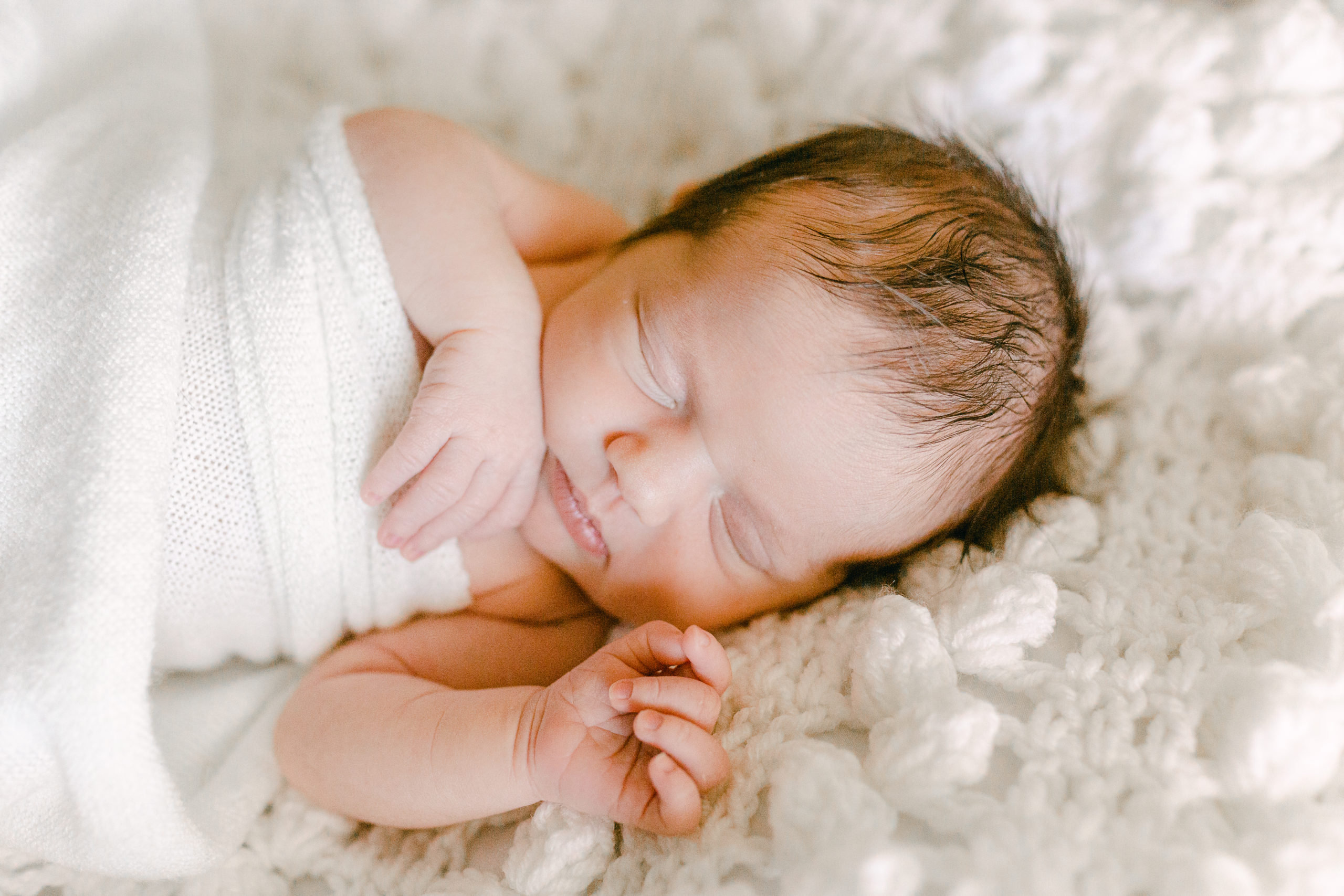 newborn baby girl lying on white blanket, Huntsville AL newborn photographer