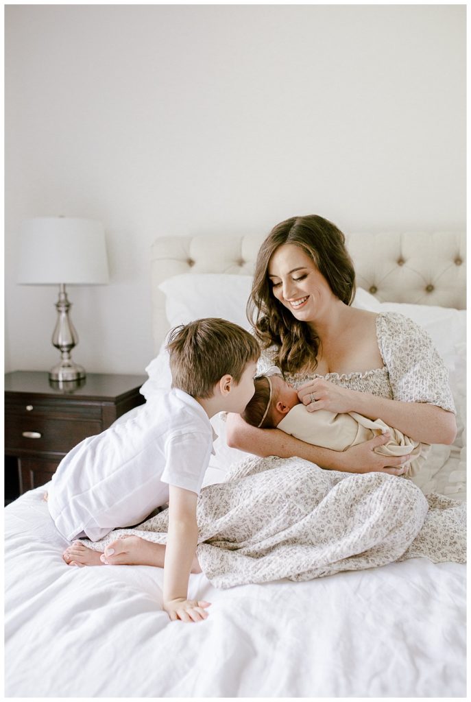 newborn session tips, mom holding baby and big brother kissing baby's head