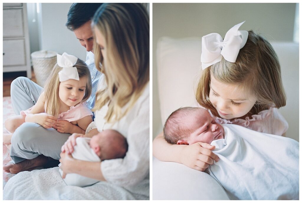 big sister holding and admiring baby at huntsville lifestyle newborn session