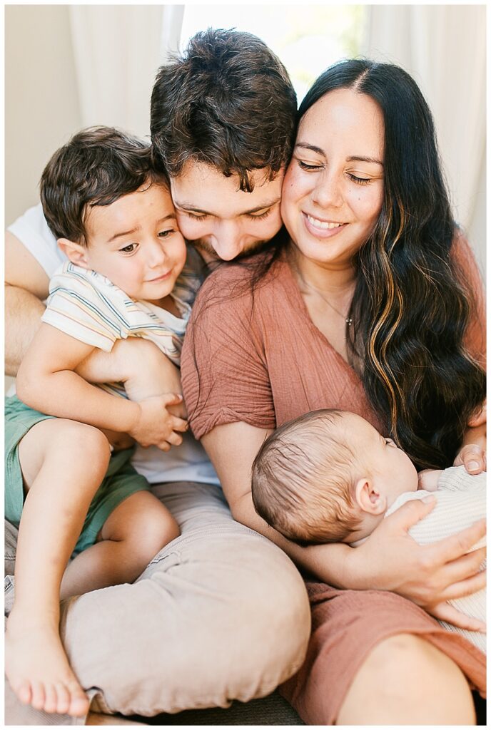 huntsville in-home family photos, mom dad two boys snuggling close