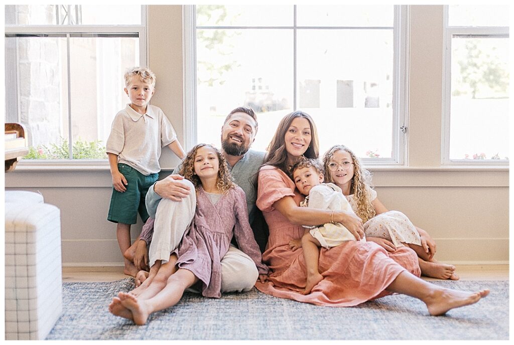 family of 6 smiling in their home